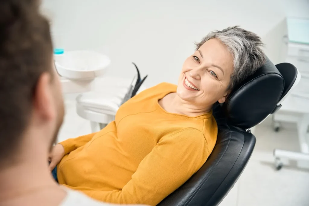Woman client sitting in denturist chair